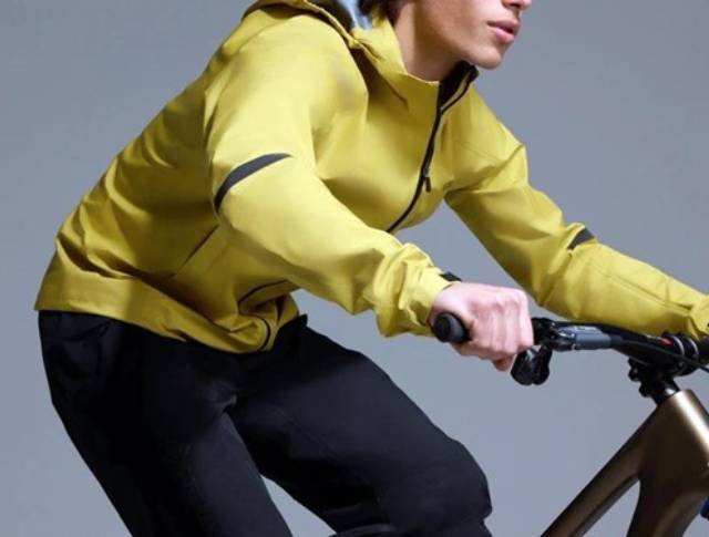 Personne faisant du vélo portant une veste extérieure jaune