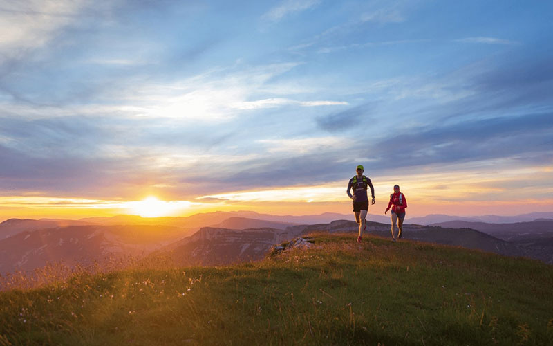 Le soleil donne sur les montagnes et les runner